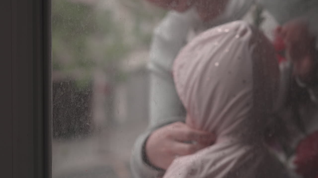 격리된 아이와 함께 어머니가 코로나19에 맞서 싸우는 의사들을 박수를 치고 있습니다.