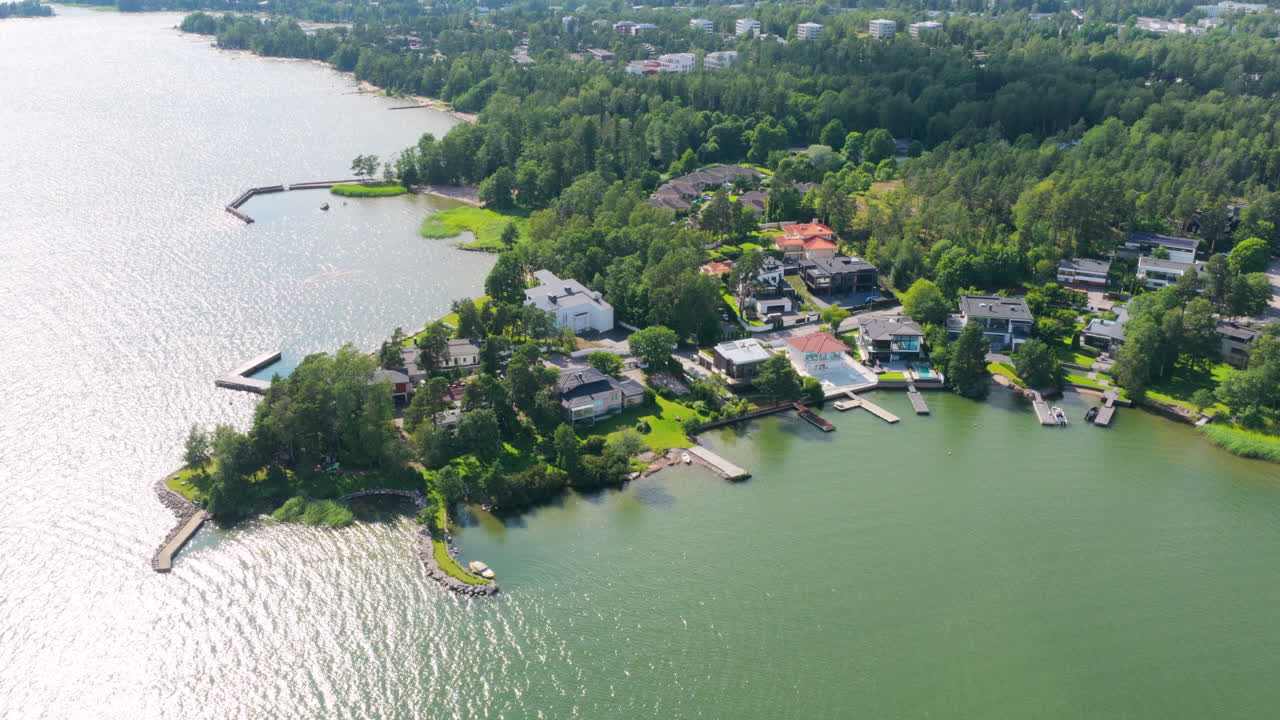 Aerial view circling upscale homes of Westend, summer day in Espoo, Finland