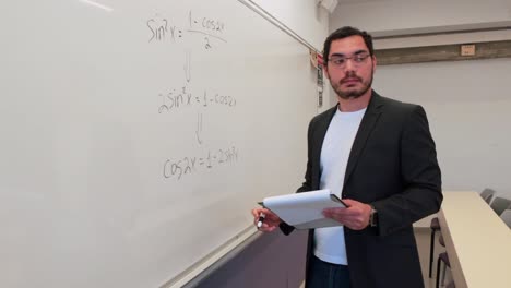 teacher demonstrating a problem on a whiteboard