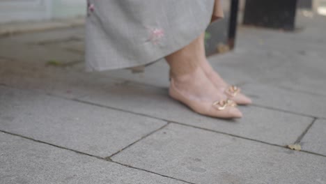 woman picking up phone on the street
