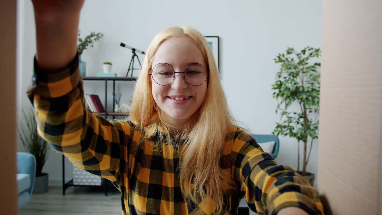 Excited Girl Unboxing Gifts and Headphones
