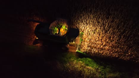 Combine-harvesting-corn-after-dark-in-autumn