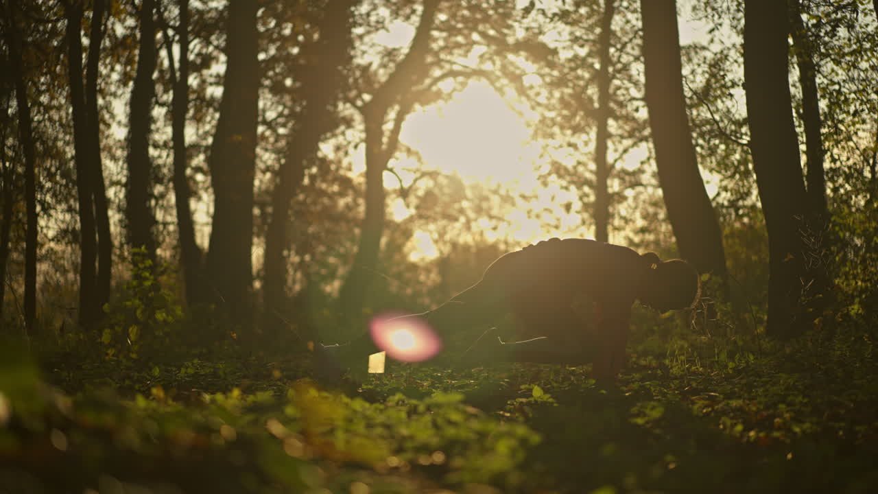 Woman exercising in nature during golden hour