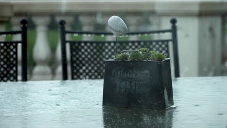 rain falls on the table and chairs - slow motion