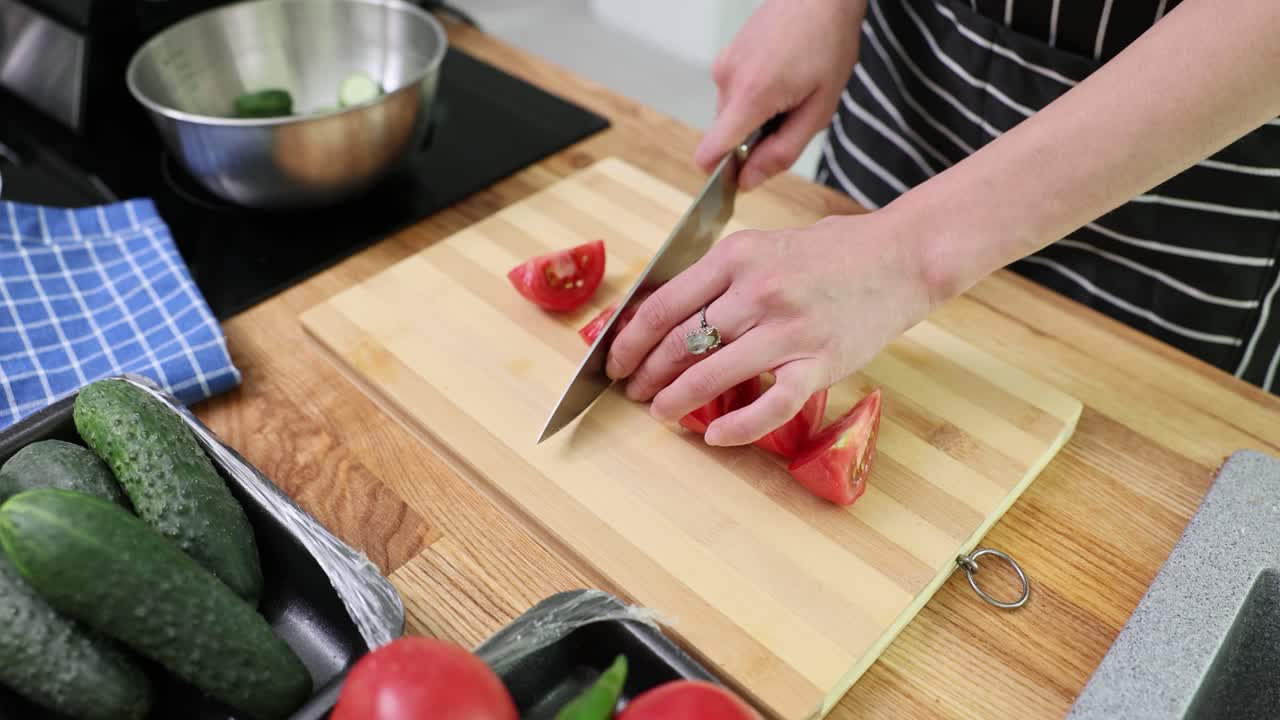 Preparing salad with tomatoes and cucumbers