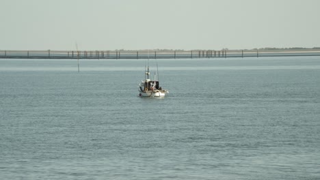 Fishing-boat-in-front-of-the-coastline-of-Hörnum-of-Sylt-in-the-Northsea-4k-60fps