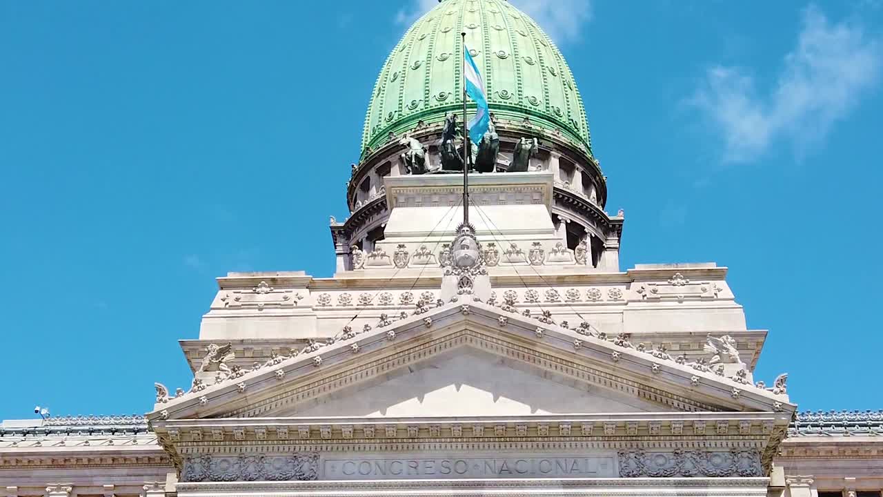 Close up at Congress of Argentina in Buenos Aires City, national flag waves over green dome and skyline