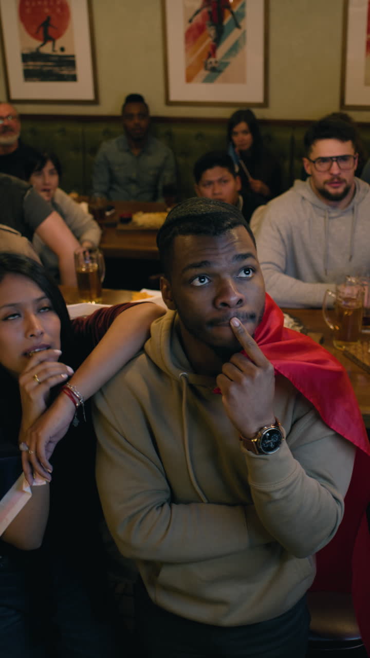 Sports Fans Watching a Match in a Pub