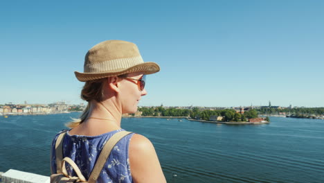 the woman admires the beautiful view of the lake and the islands of stockholm travel to scandinavia