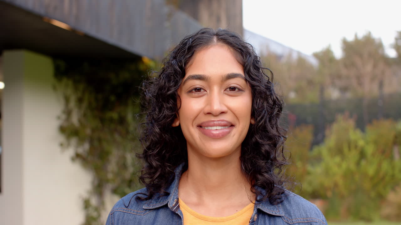 Smiling woman outdoors, enjoying time with friends, casual and relaxed atmosphere