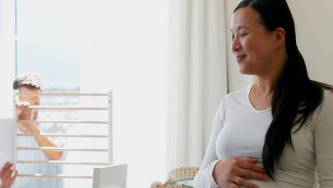 man making cot with pregnant woman in bedroom 4k