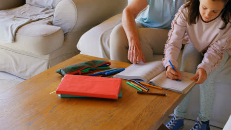 Front-view-of-Old-Caucasian-grandmother-helping-her-granddaughter-with-homework-at-home-4k