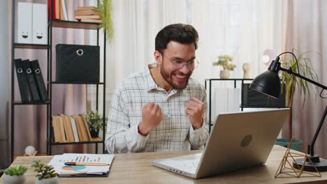 indian business man working on laptop shocked by sudden victory game winning lottery good news