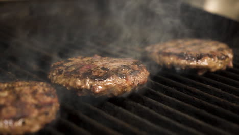 flame grilled hamburger patties sizzle smoke over grate, 4k