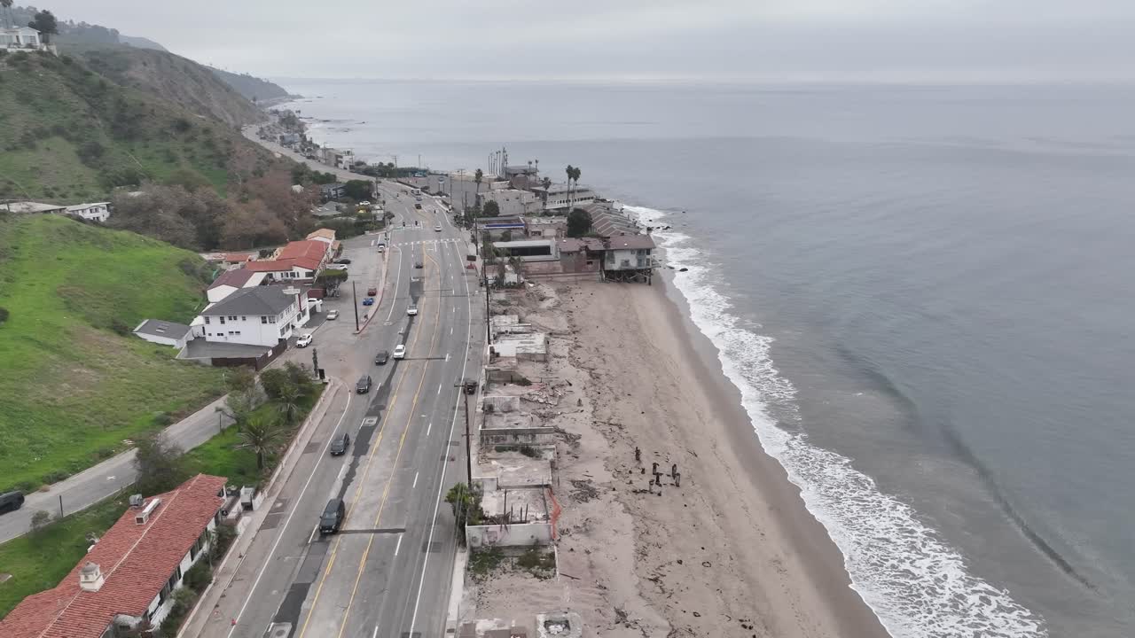 An aerial shot over Malibu’s coastline combines a burn-down motion with a rightward spin, revealing the Pacific Ocean, cliffs, and urban areas in a dynamic panorama