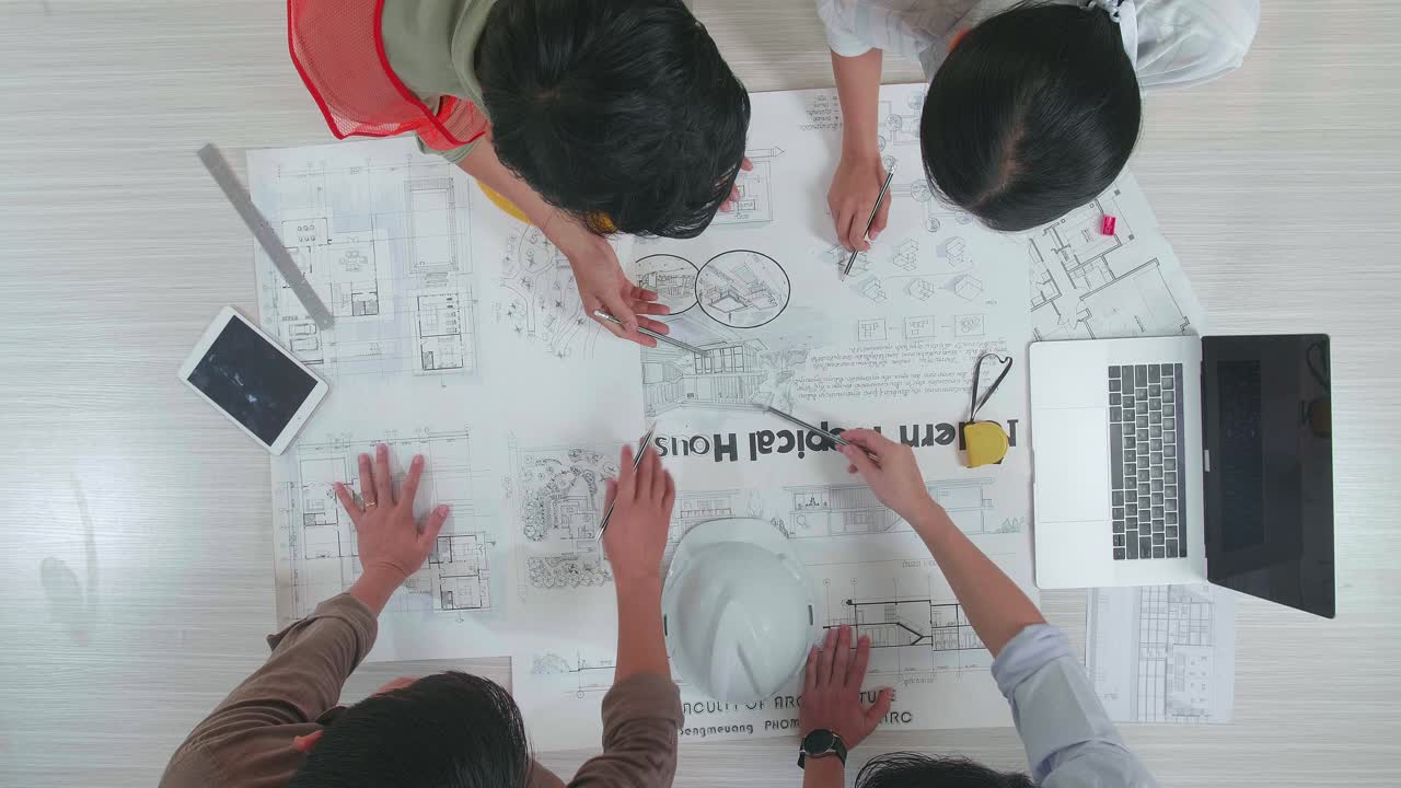 Group Of Group Asian Engineers Discuss About Work At The Office