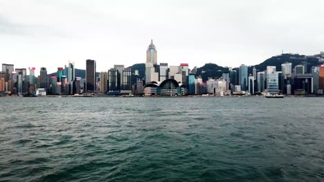 hyperlapse of hong kong skyline with boats passing, moving from left to right