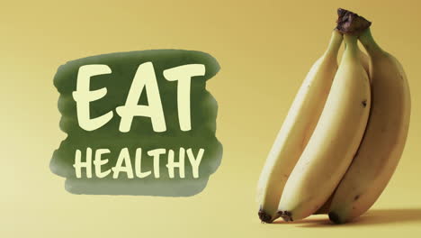 animation of eat healthy text over bananas on yellow background