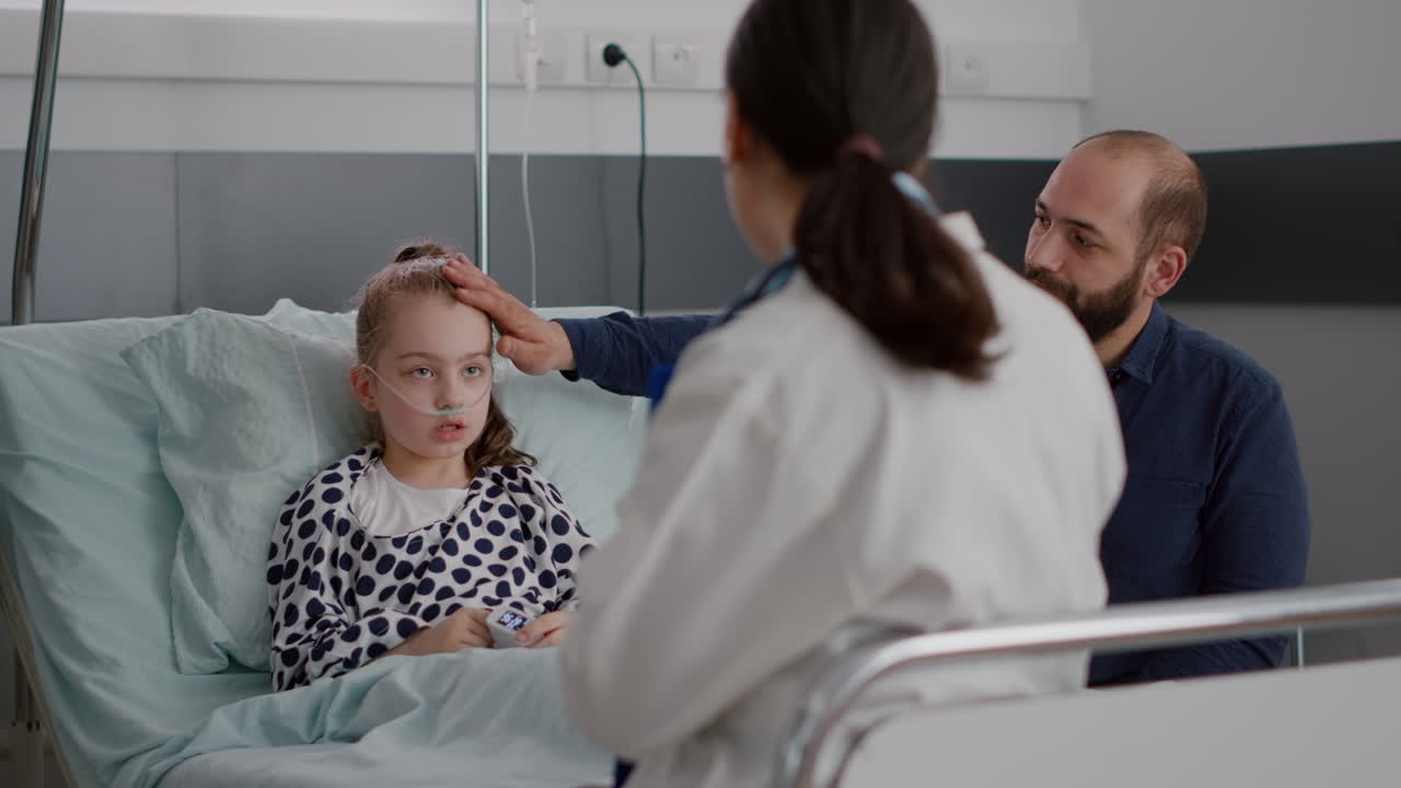Pediatrician doctor discussing sickness treatment with sick patient and father