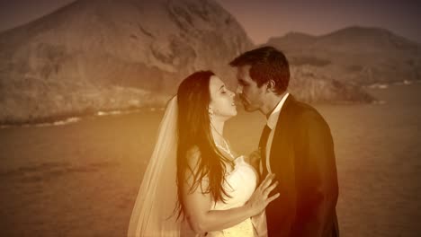 recent newlyweds married couple showing affection hugging carressing kissing and loving each other on wedding day sunset beach sea coast bridal photoshoot location close up slow motion color graded hd