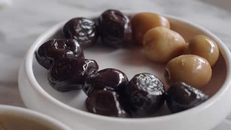 close-up of a plate of black and green olives