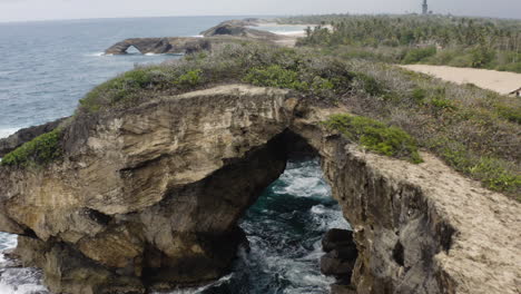 Aerial-View-Of-El-Indio-Cave-In-Las-Piedras,-Puerto-Rico---drone-shot