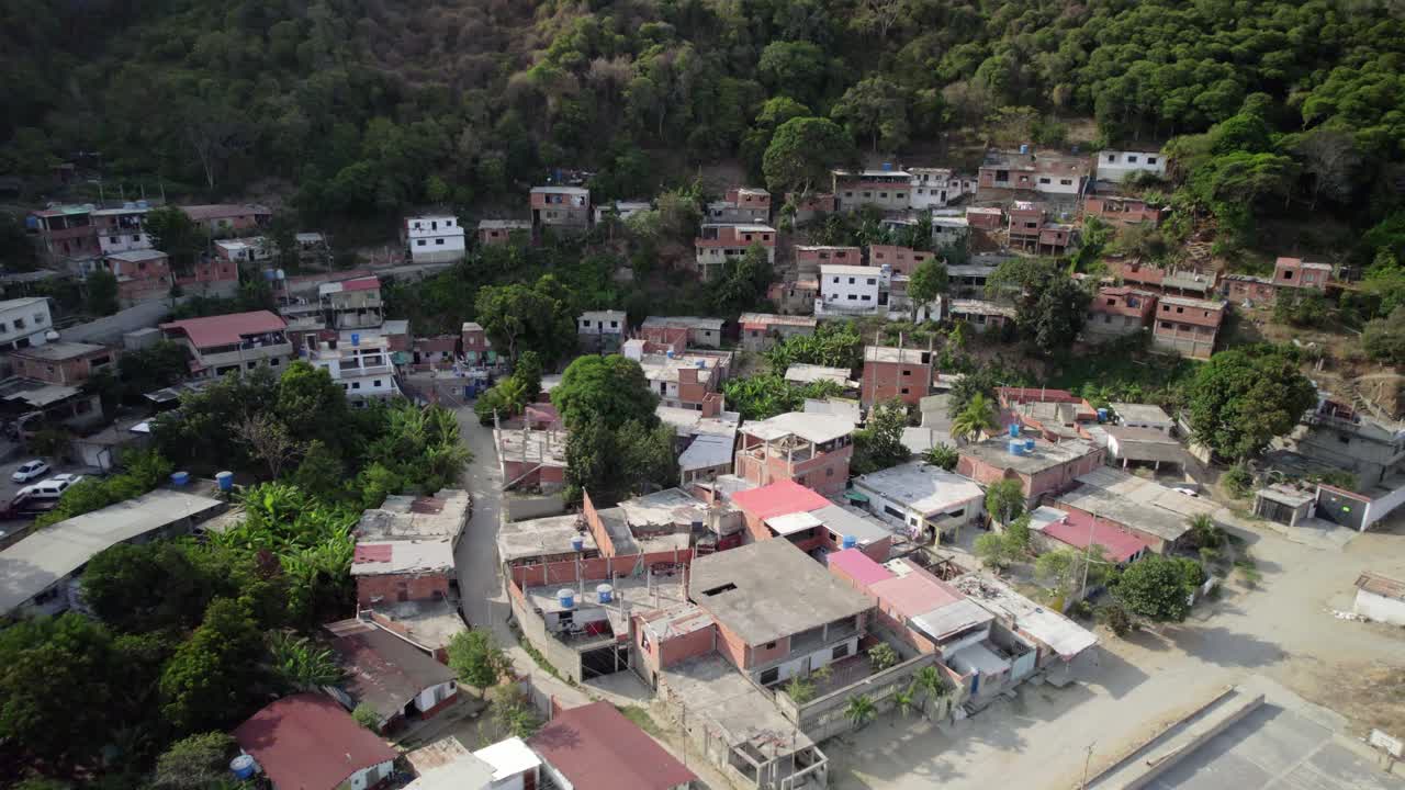 Humble houses in the mountains of camuri grande, next to the river, aerial view