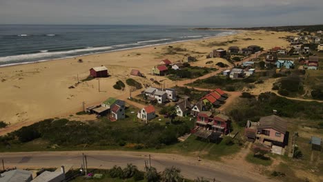 colorful cottage houses front to atlantic ocean, punta del diablo, uruguay