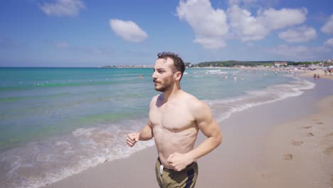 Young-man-jogging-on-the-beach.