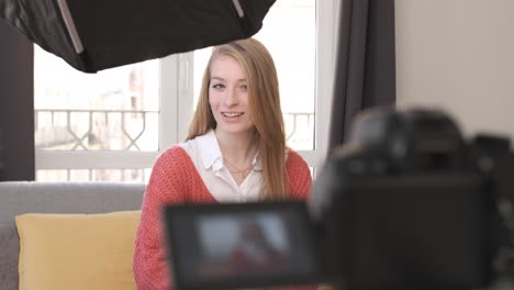 vlogger recording youtube video at living room with camera