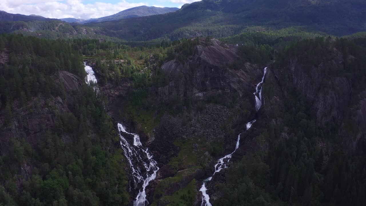 Stunning norwegian landscape with waterfalls and green forested mountains, aerial view