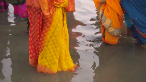 indian woman touching feet of elderly