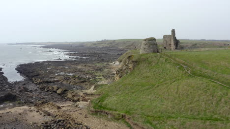 An-aerial-view-of-Newark-Castle-on-the-Fife-coastal-path,-Scotland