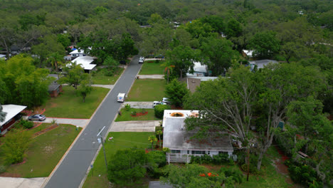 a street through a residential area in tampa, florida. aerial drone shot right to left