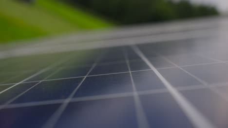 close up panning downward view of photovoltaic pv solar panel in field, ecology-zero emission technology, beautiful blurred defocused background