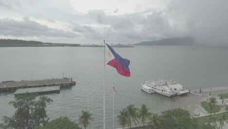 the philippine flag flutters gracefully in the breeze, colors vibrant against the sky, each ripple and fold telling a story of pride and heritage, capturing attention with its rhythmic dance.