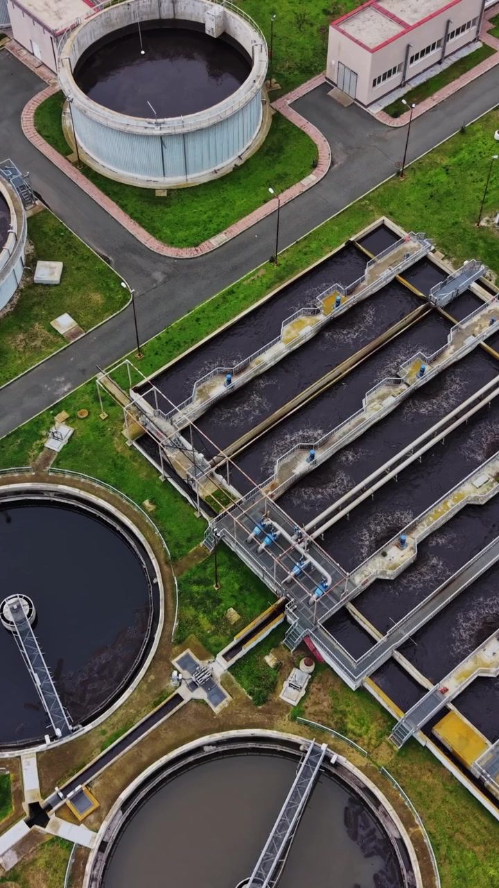 Wastewater treatment facility shows tanks and processing areas in action