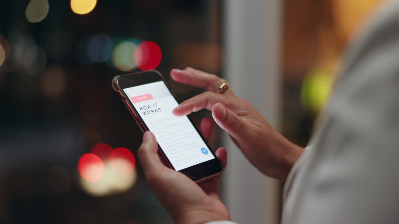 Woman using smartphone with business website at night