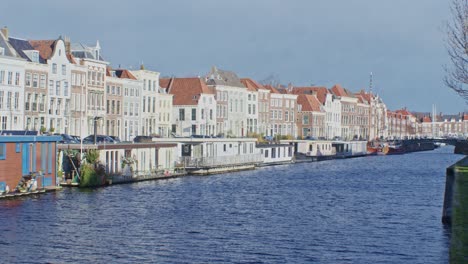 dutch european street view in netherlands with houses, water, canal and traditional classic architecture design view