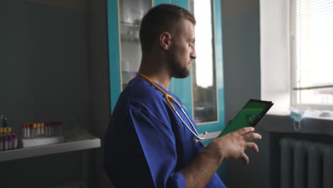 male doctor talking with someone using tablet. medical worker consult patient on digital device. physician working in lab during corona pandemic. health and modern technology concept.