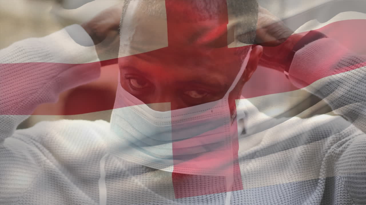 animación de la bandera de inglaterra ondeando sobre un hombre que usa una máscara facial durante la pandemia de covid-19