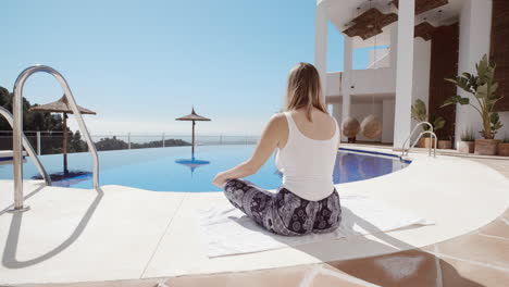 Slow-motion-dolly-shot-of-natural-woman-in-bohemian-outfit-meditating