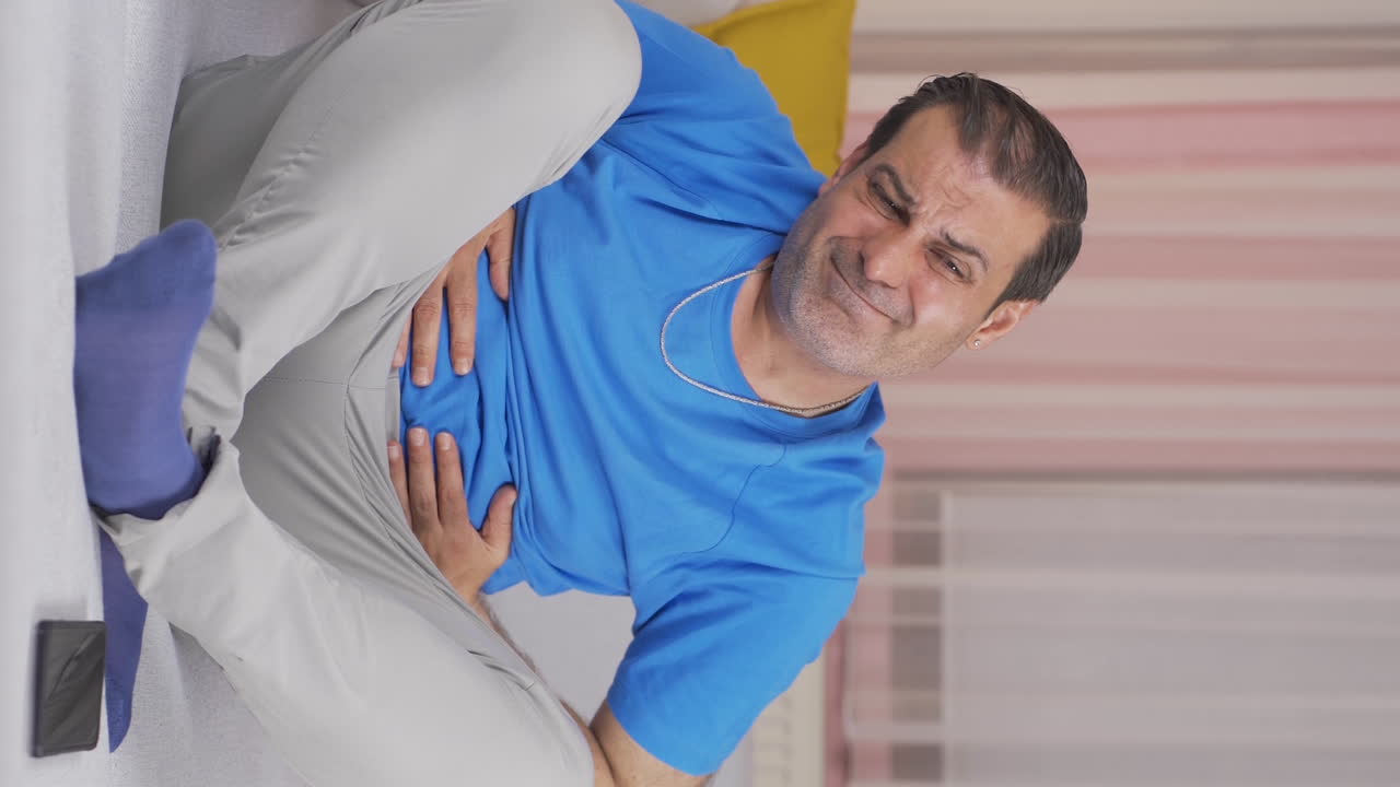 Vertical video of Man with stomachache.
