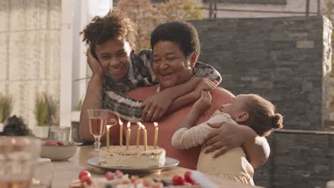 woman celebrating birthday with grandchildren