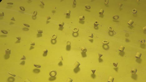 Cheerful Yellow. 3D animation of a seamless contour background of sunny bright yellow cubes, bagels, cylinders, rotating. Great for presentations. Put your own text in it