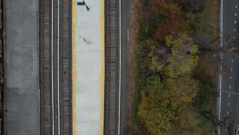 a top down view of a train station with a construction train on the track