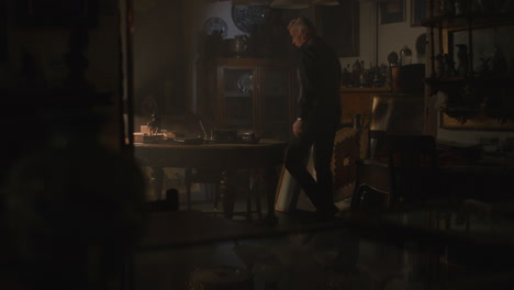 old passionate man sits down to his desk