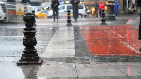 people walking in the rain on a city street