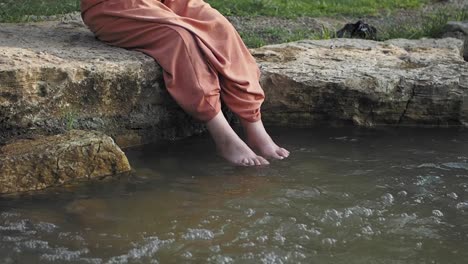 woman's feet in a creek