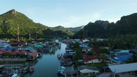 moving backwards the drone reveals a fishing community, bang pu fishing village, sam roi yot national park, prachuap khiri khan, thailand